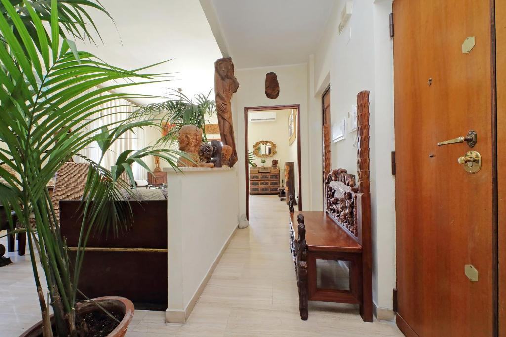 Corridor with carved wooden figures and a carved bench